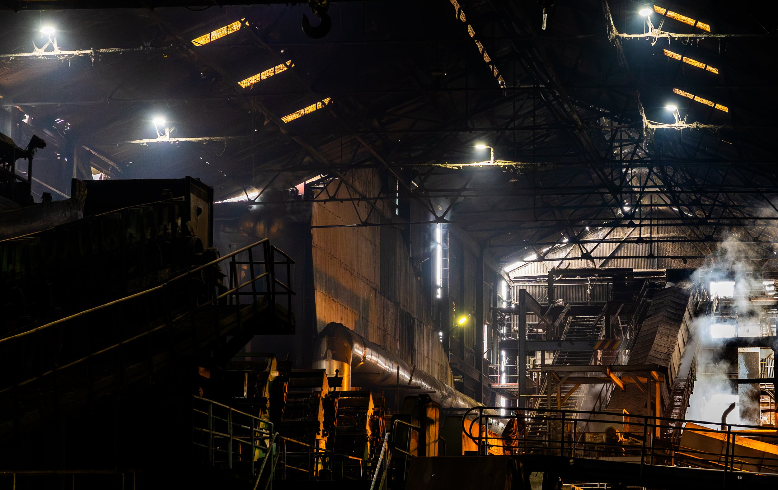 Glow piercing the factory’s steamy iron depths