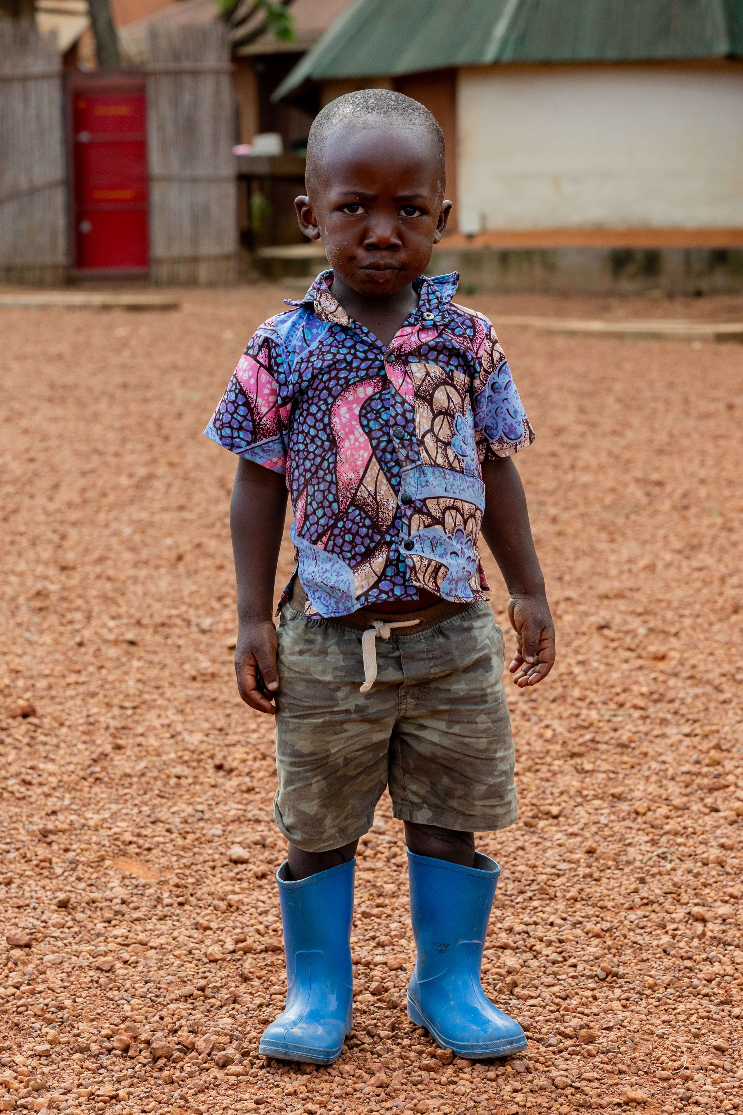 Serious gaze in blue boots stance