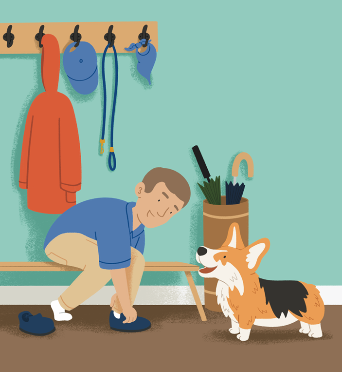 A boy is putting on shoes in a mudroom next to a happy corgi dog. The room has hooks with jackets and hats, and a container with umbrellas and umbrellas on top.