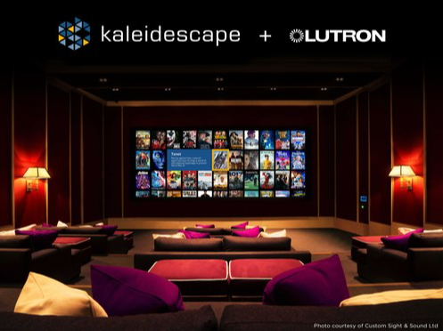 A modern home theater with a large screen displaying multiple movie posters, surrounded by dark walls, purple and beige seating, and wall-mounted lamps.