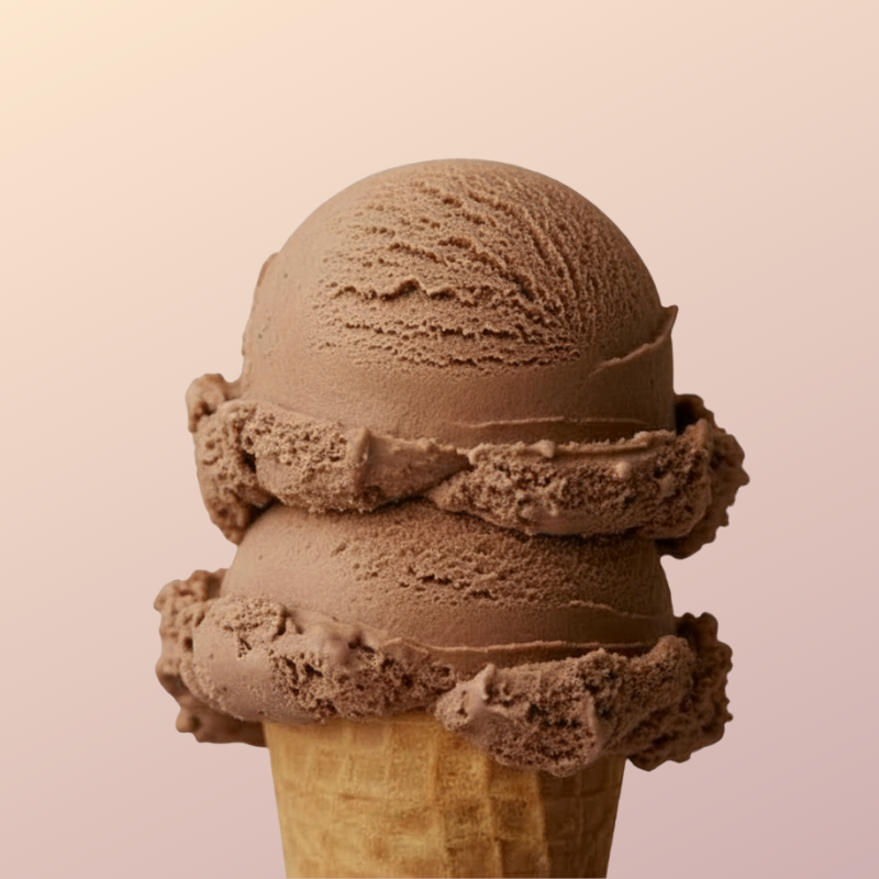 A close-up of a scoop of chocolate ice cream on a cone with a plain background.