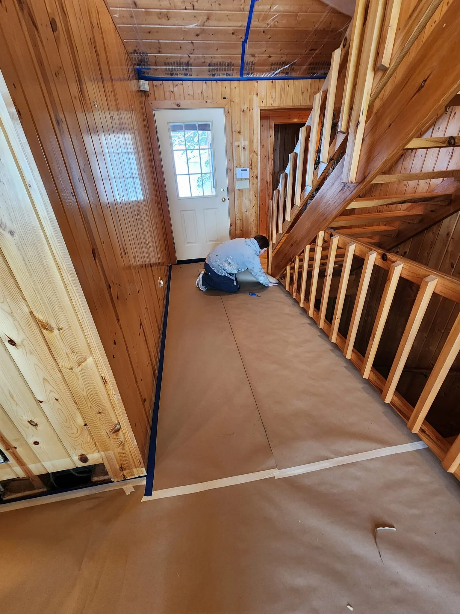 Hardwood floor being prepped off with paper for protection