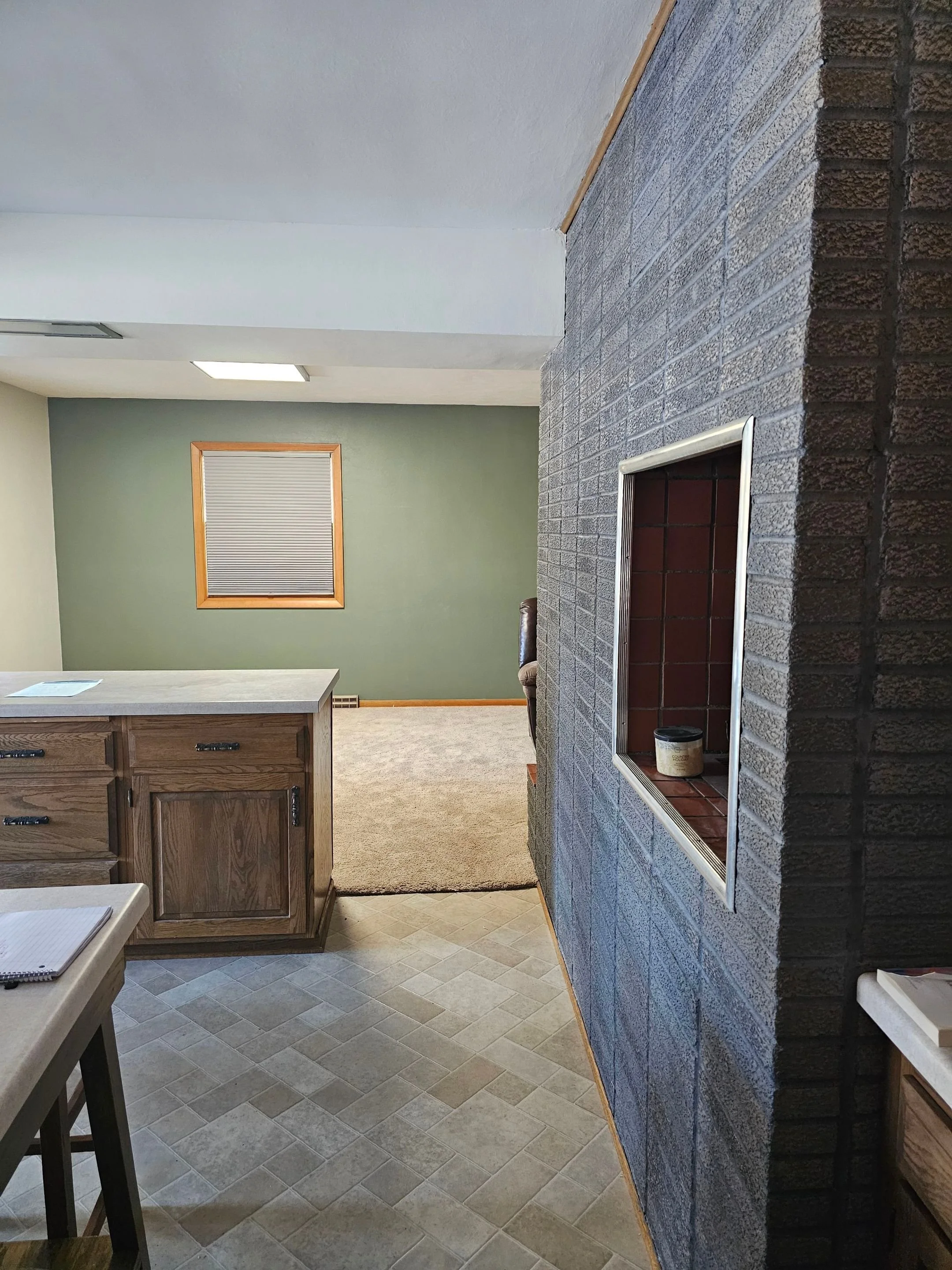 Brick stain and green walls for living room and kitchen makeovers by Barefoot Painter LLC