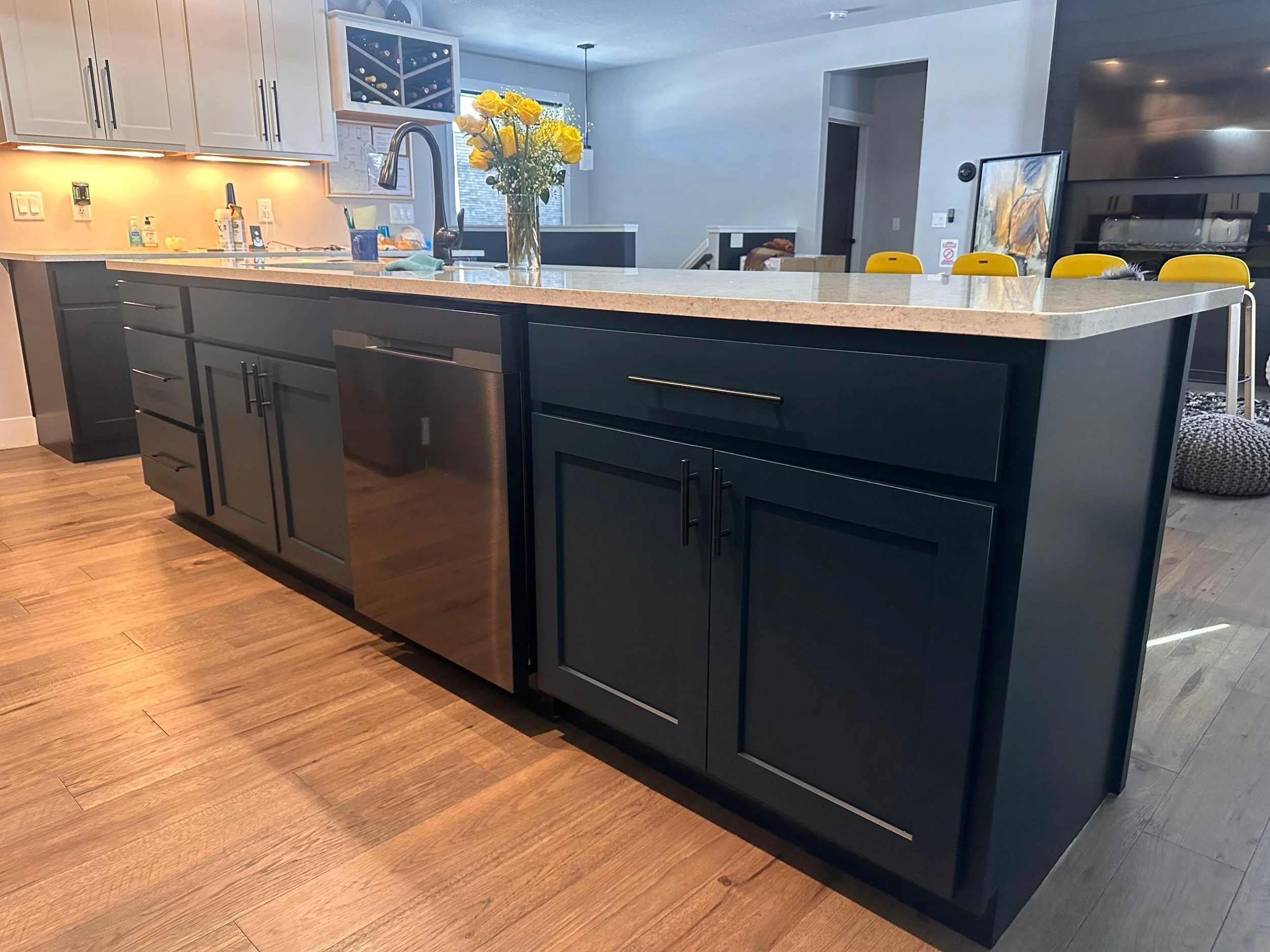 Dark blue island in a modern home professionally painted by Barefoot Painter LLC in Eau Claire Wisconsin