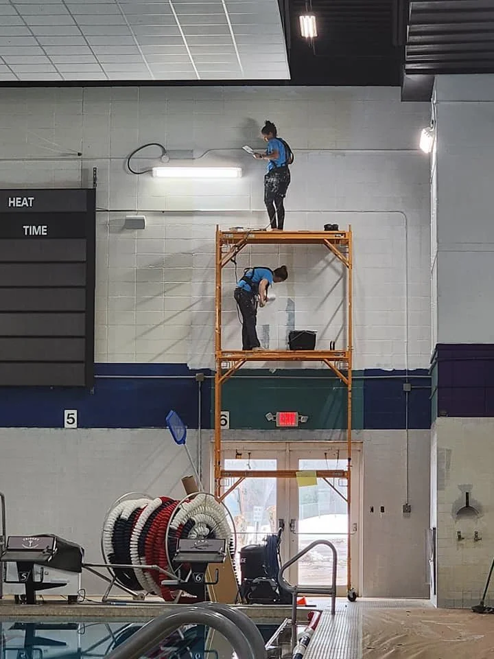 Safety first with Barefoot Painter LLC harness use with on scaffolding painting pool area for Trident and Flambeau Area Swim Team pools