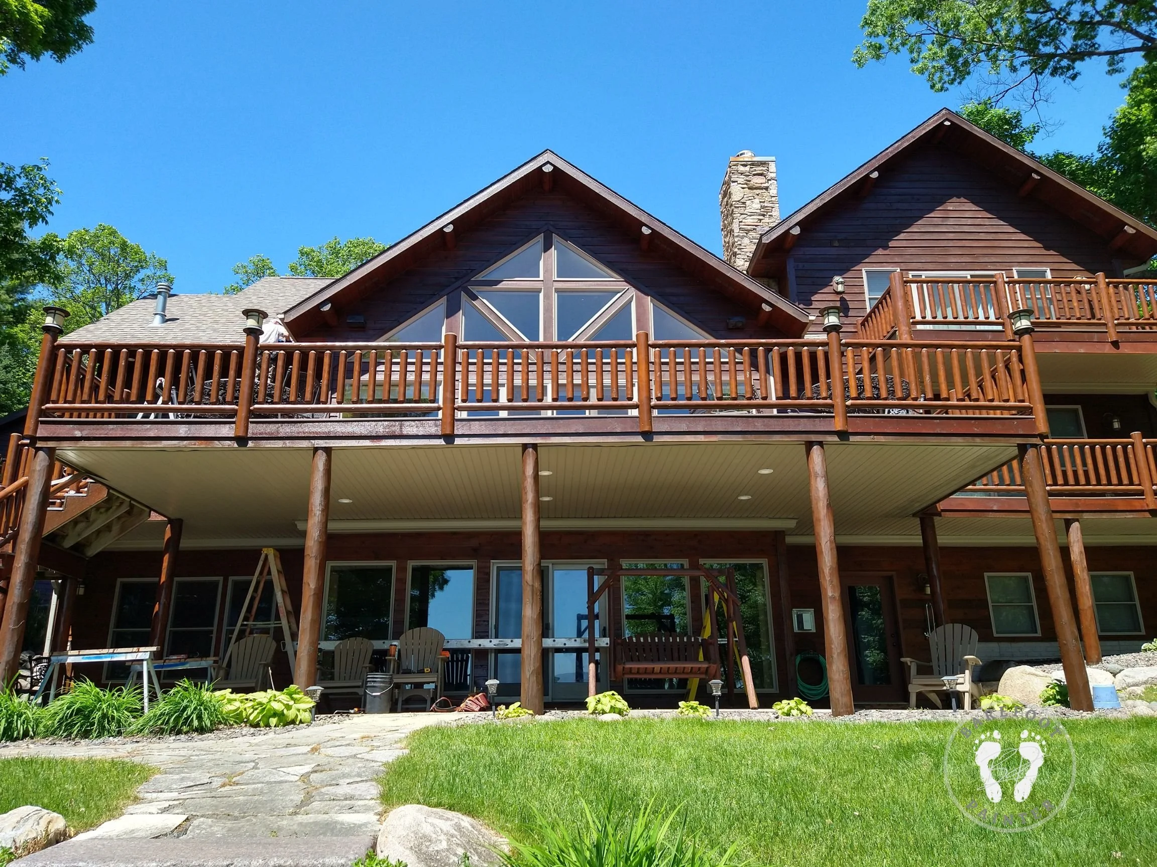 Lakefront log home staining using oil stain after power washing