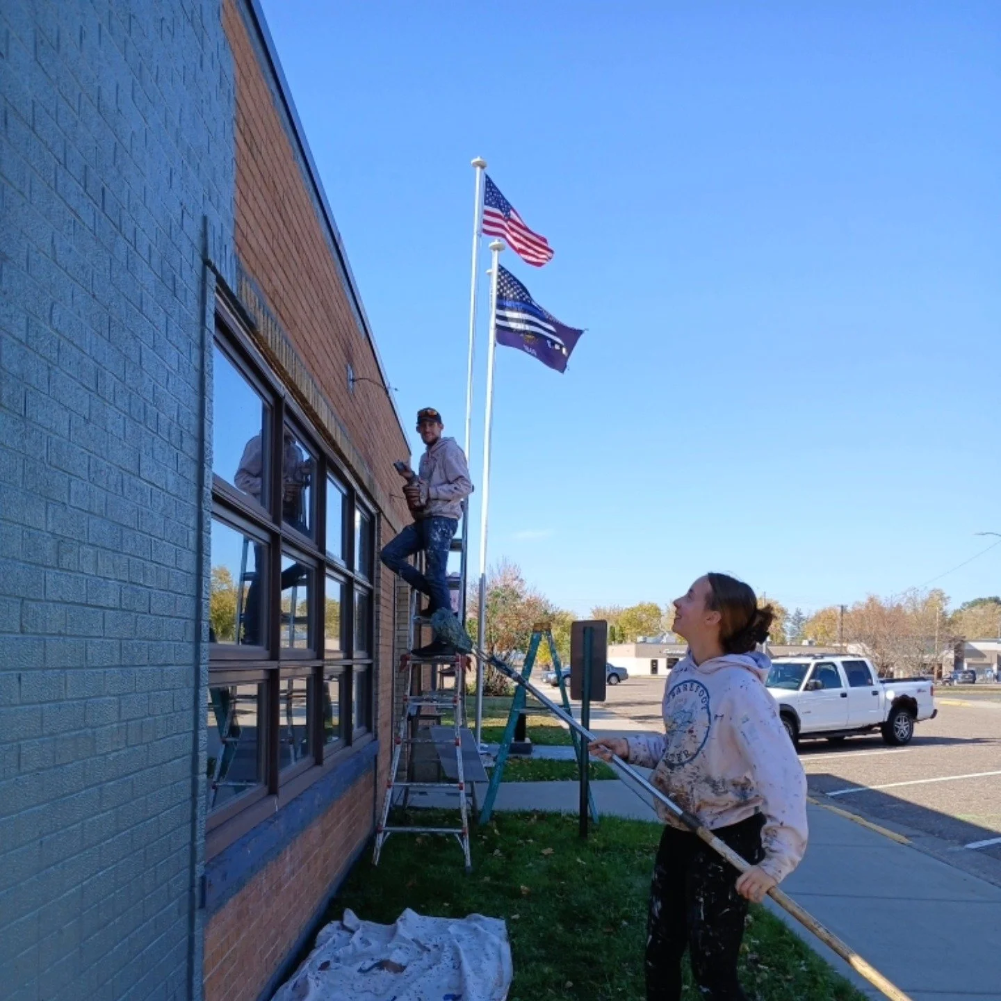 Staff of Barefoot Painter LLC painting the exterior of the Chetek Police Department
