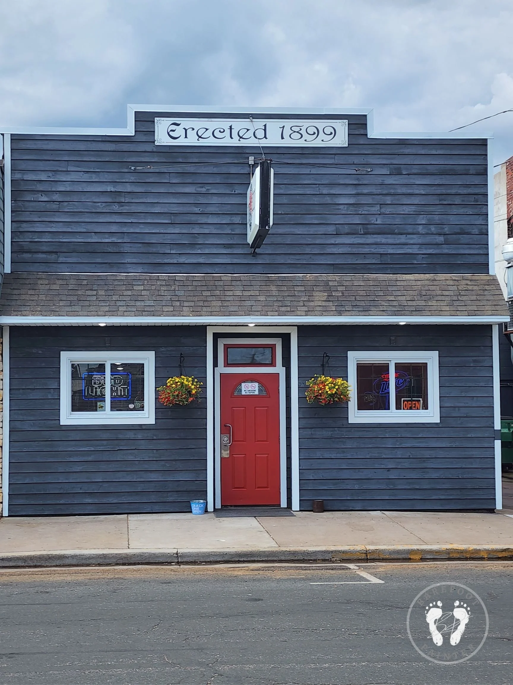 Miner Station exterior staining on Miner Avenue in Ladysmith Wisconsin with red door painting