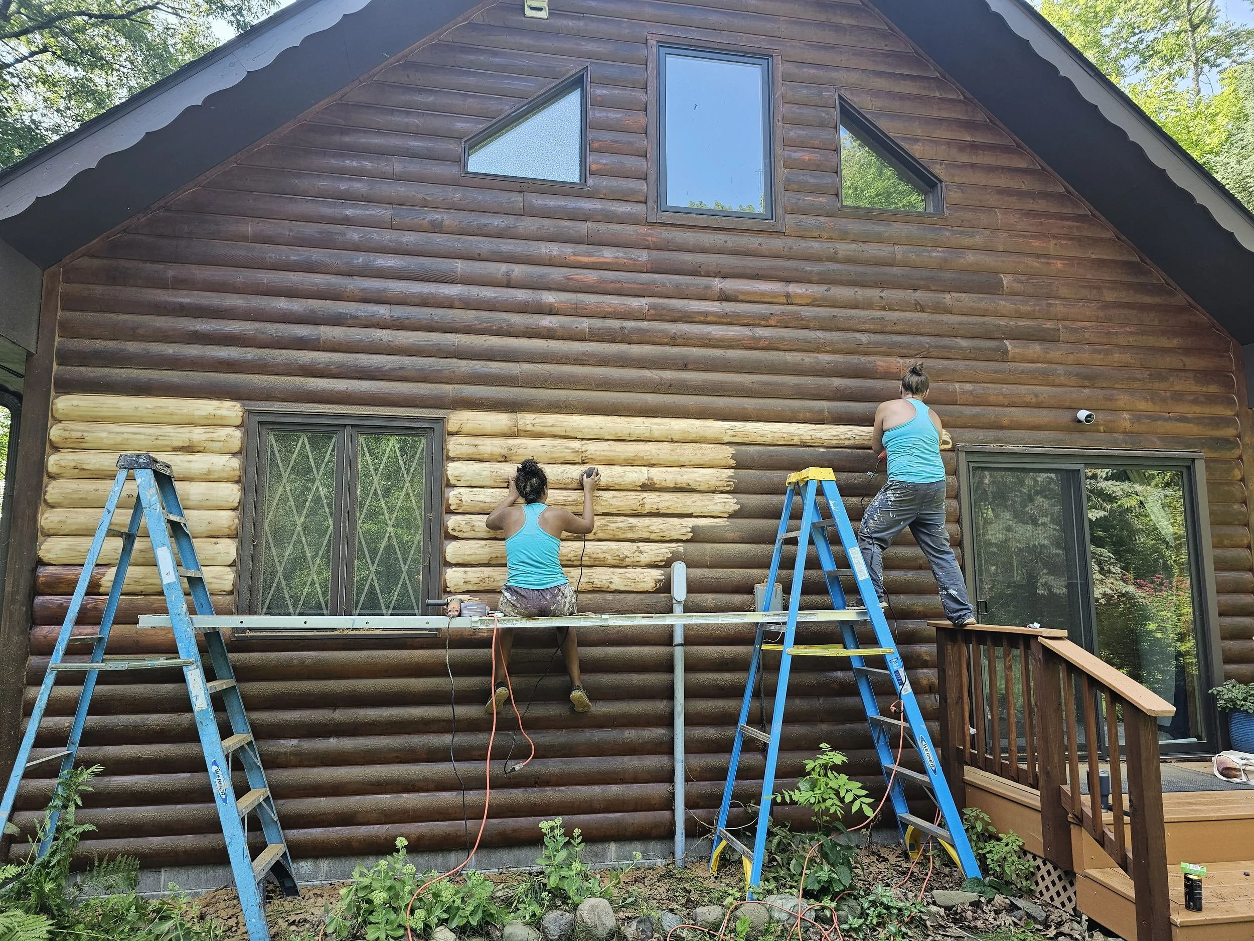 Barefoot Painter LLC painters preparing a log house for stain in Stone Lake Wisconsin