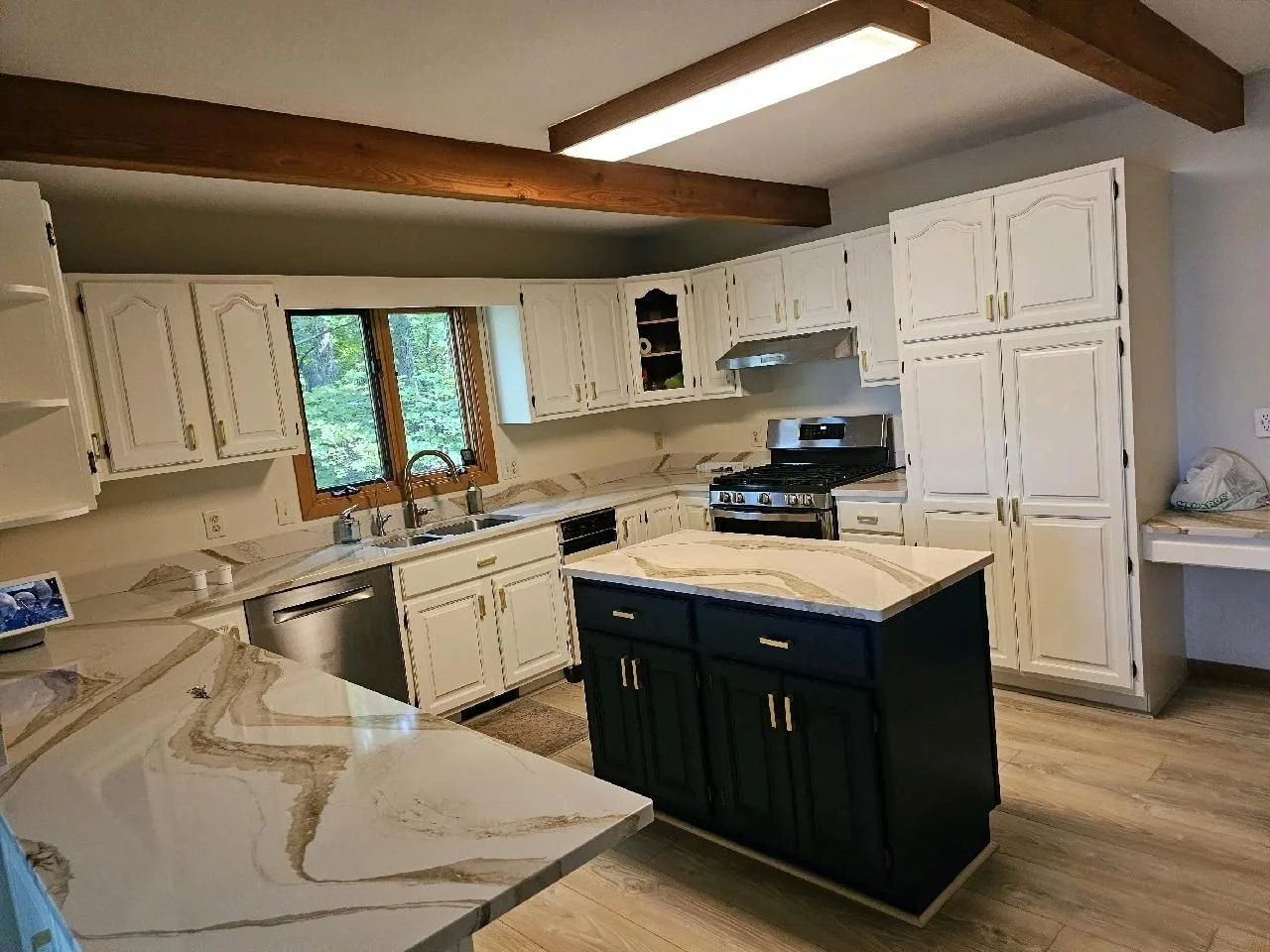 White and Navy painted kitchen cabinets with gold handles