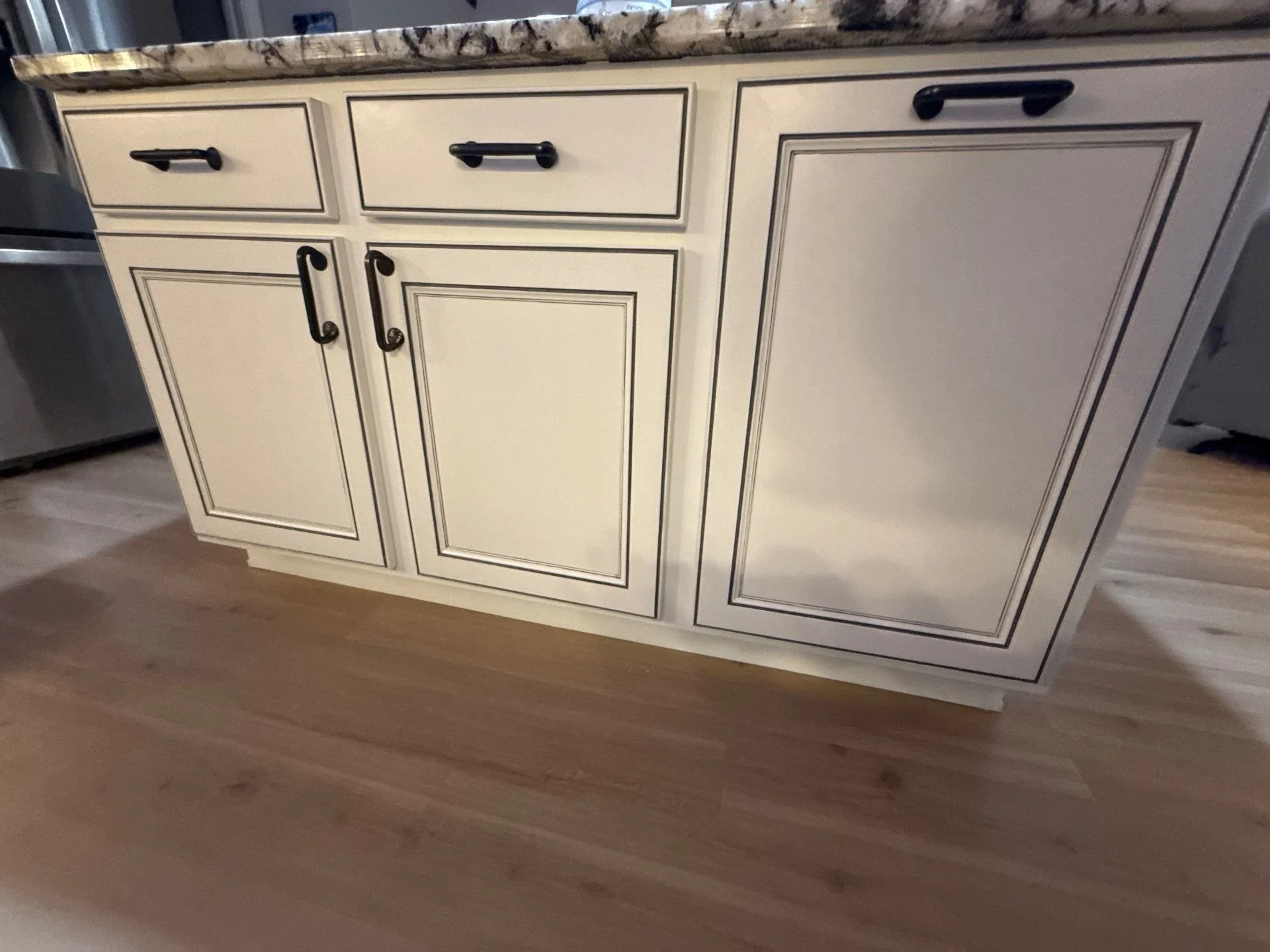 Faux white cabinet painting with black and charcoal pinstriping in Eau Claire, Wisconsin