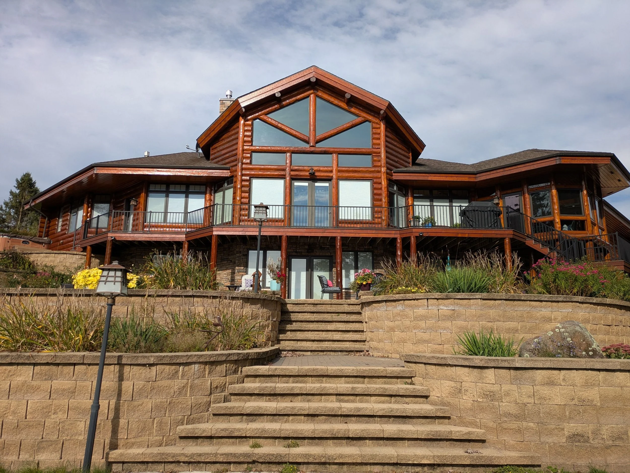 Log home exterior wood staining project completed by Barefoot Painter LLC in Chippewa County, Wisconsin