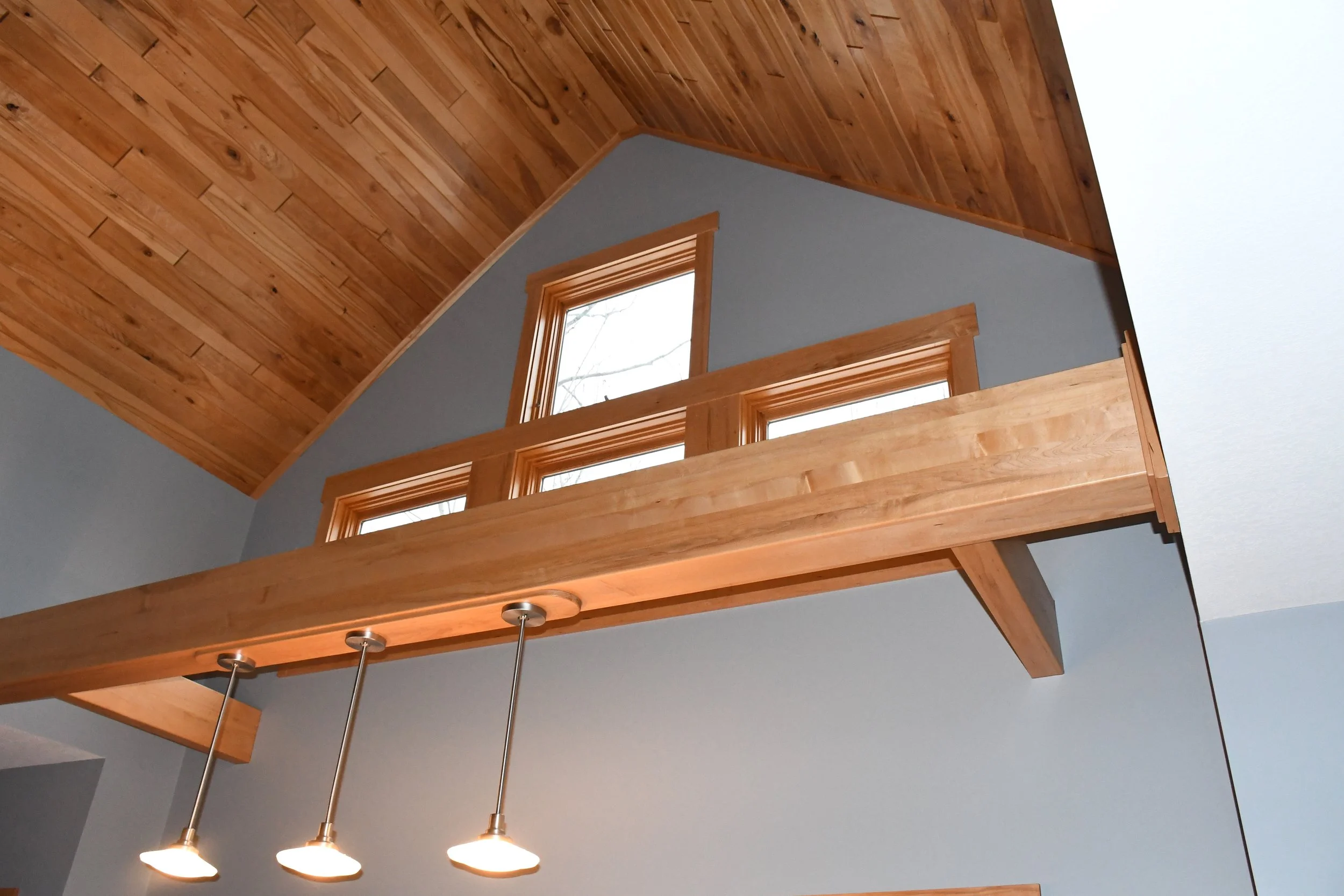 Cabin interior painting in Birchwood Wisconsin using blue and gray tones with natural wood beams