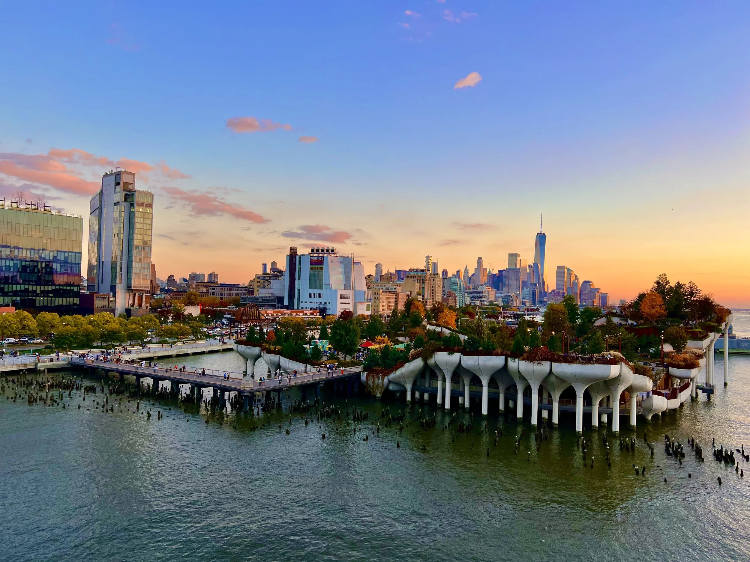 Sunset view of lower NYC Manhattan skyline with the Little Island in the foreground.