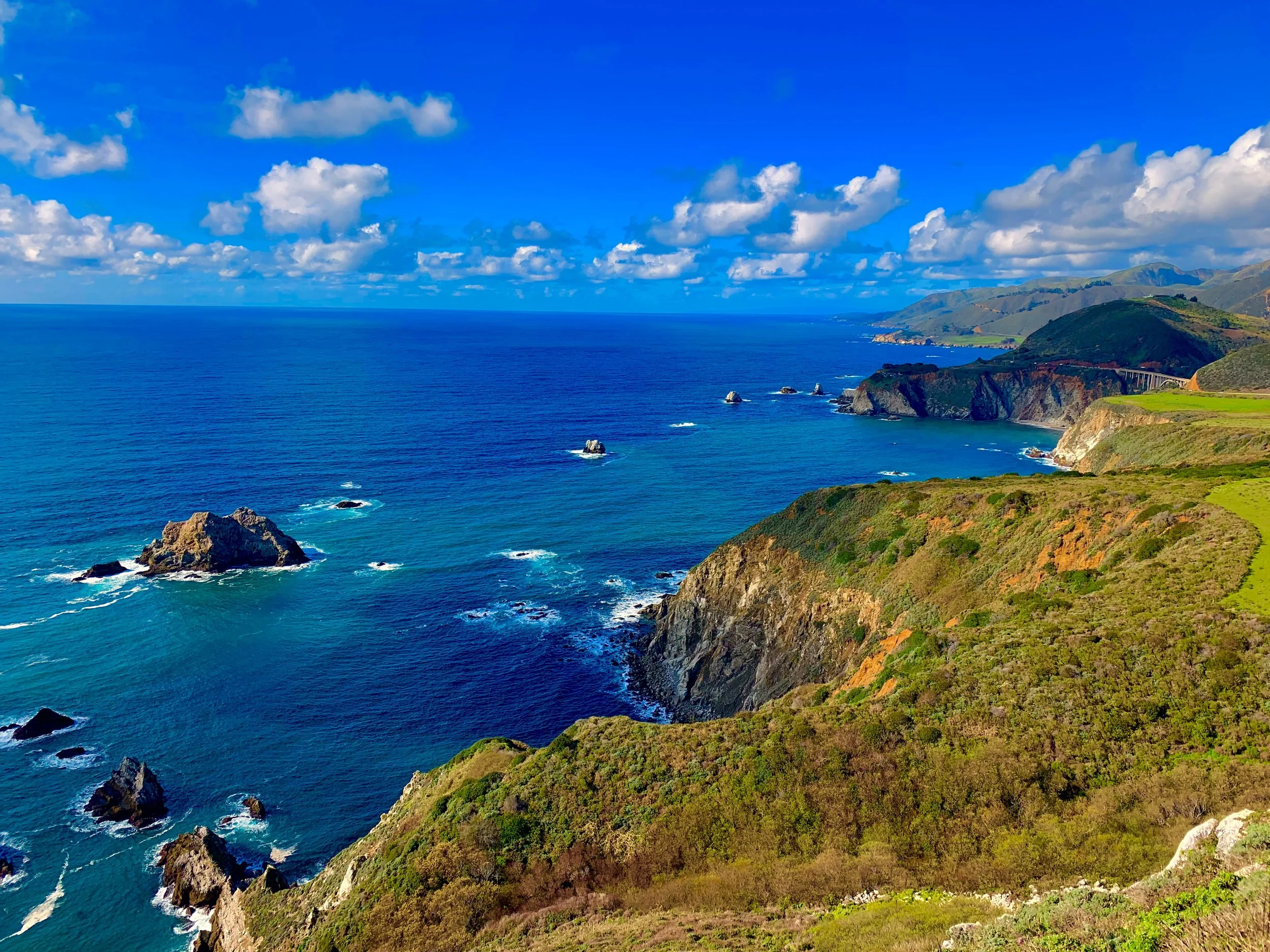 Coastal cliffs and brilliant blue ocean on a perfect California summer day.