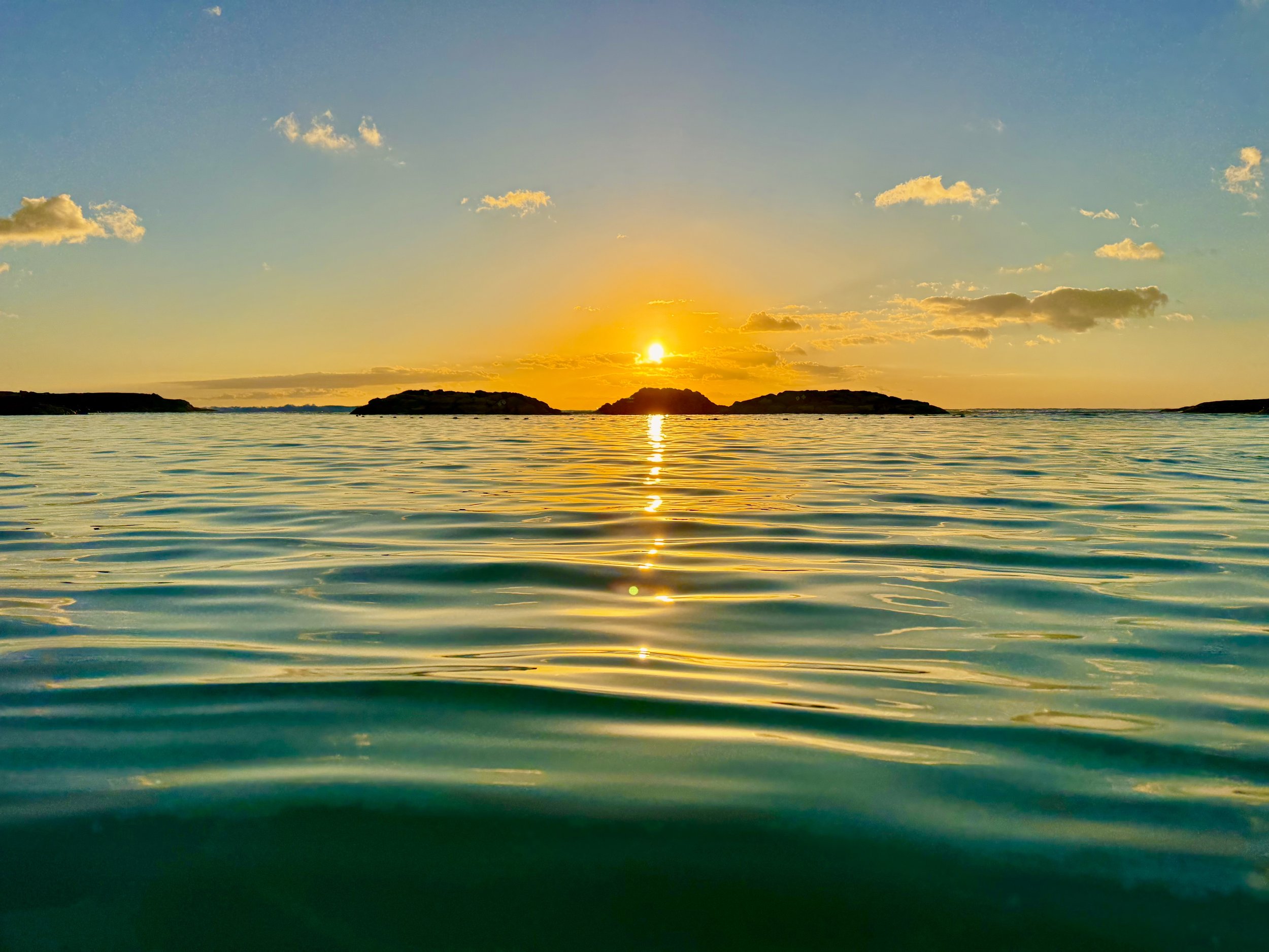 Sunset over calm ocean in Ko'Olina Oahu.