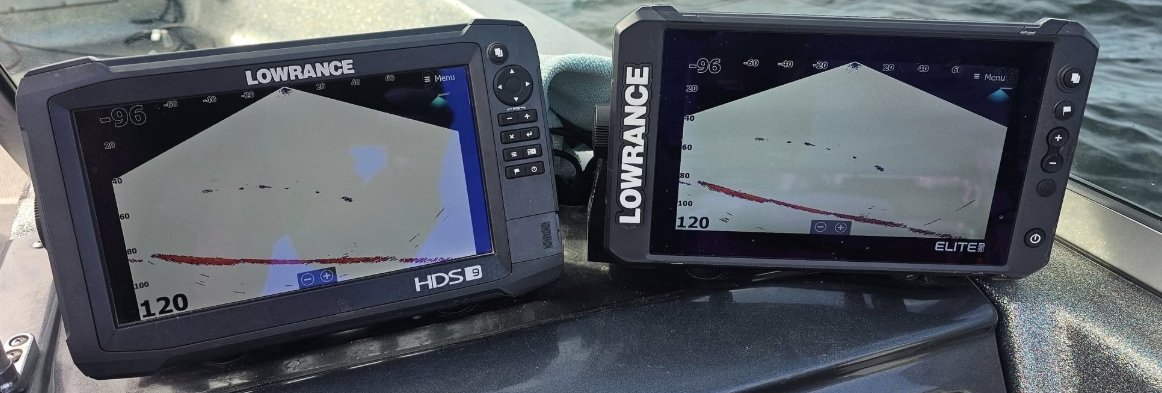 Two Lowrance fish finder screens mounted on a boat dashboard, displaying underwater sonar images of a lakebed with some fish detected.