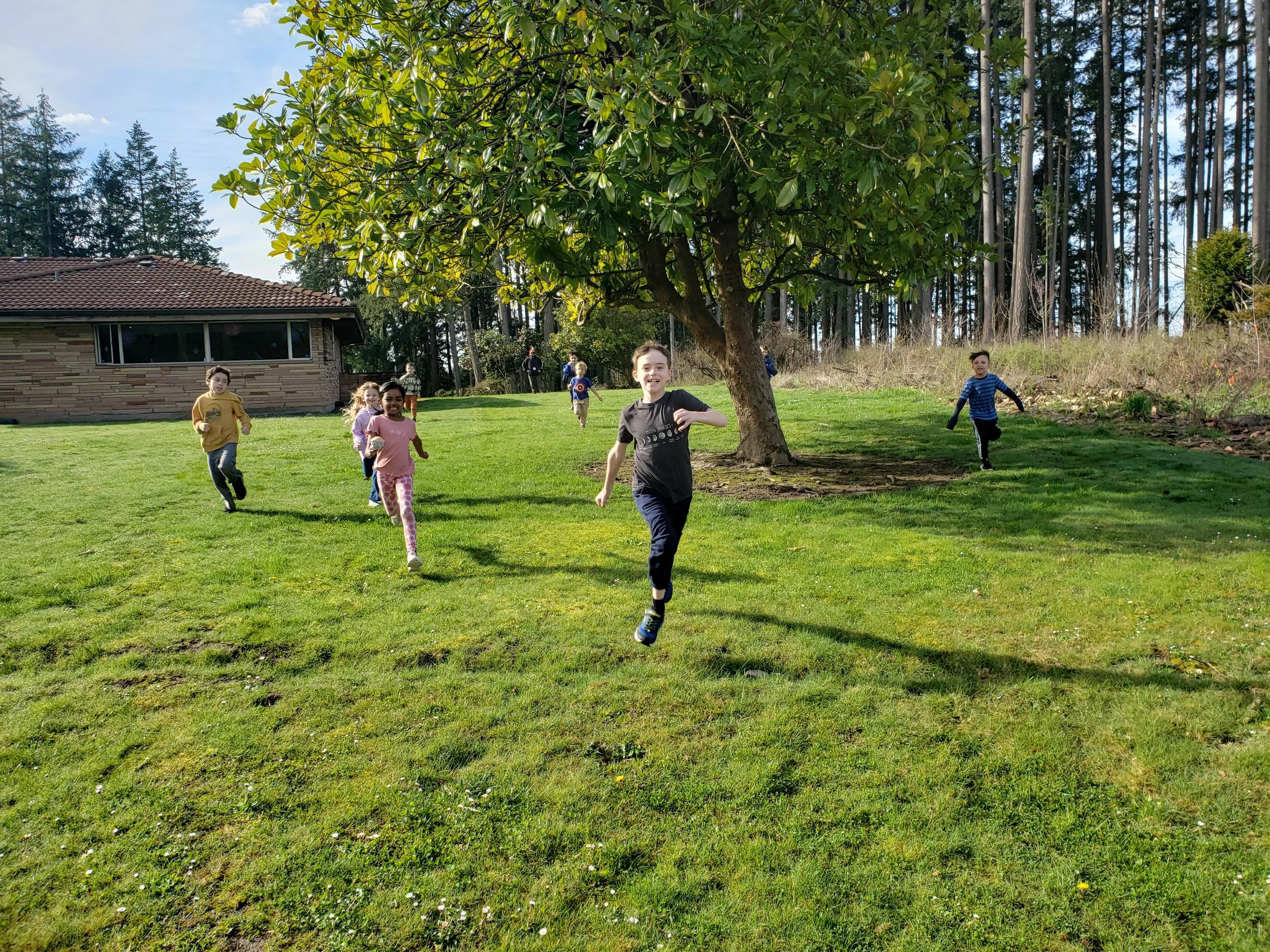 Children running the back yard of the Rice Museum.