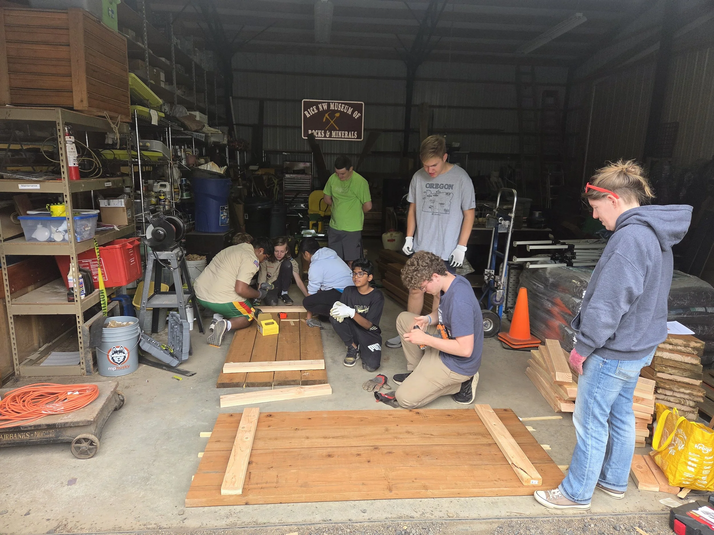 A group of people building picnic tables