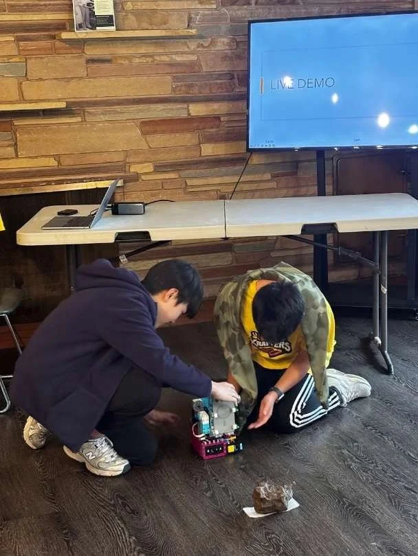 Lego Krafter team members demonstrating scanning technology of robot