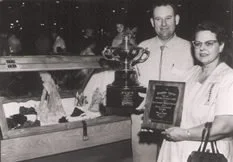Richard and Helen Rice stand with awards