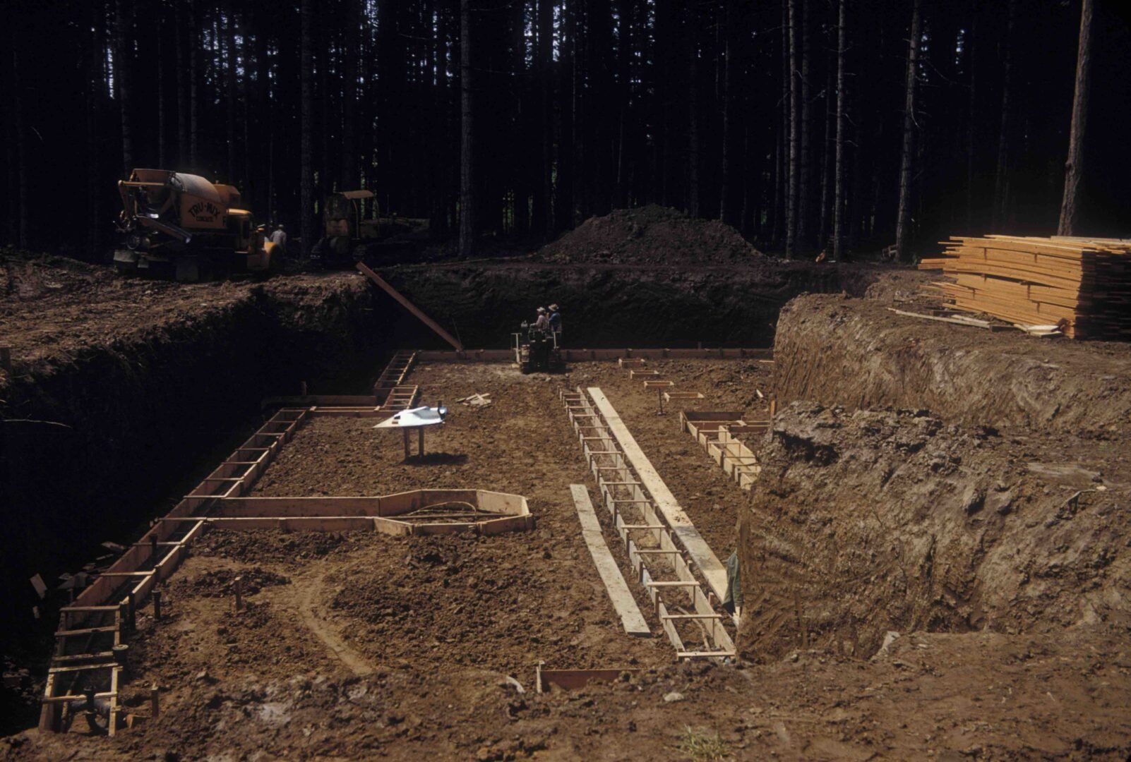 Further progress on the construction of the private residence that would later become the nonprofit museum. Several workers can be seen standing in a large trench that has been dug into the ground.