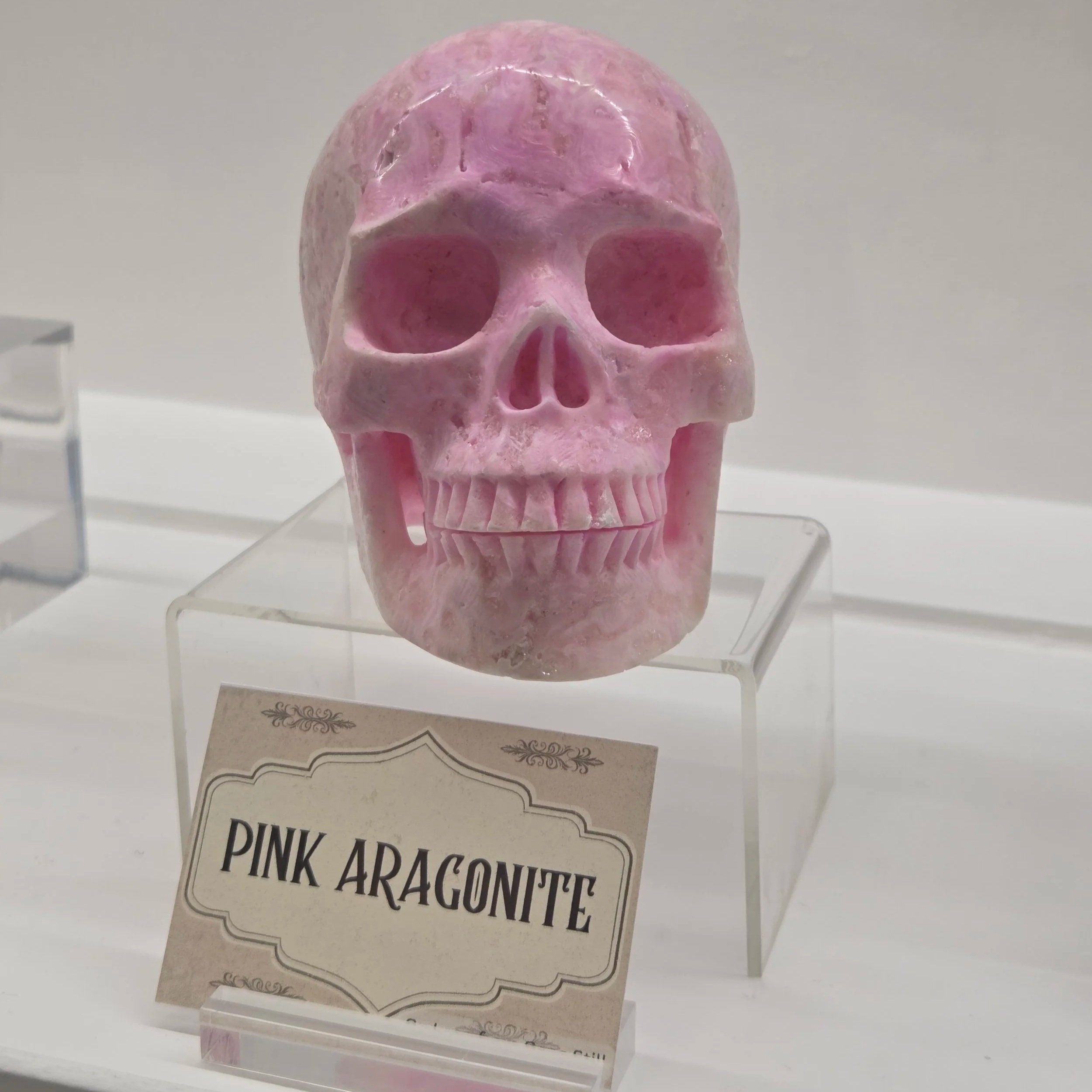 Pink aragonite stone skull