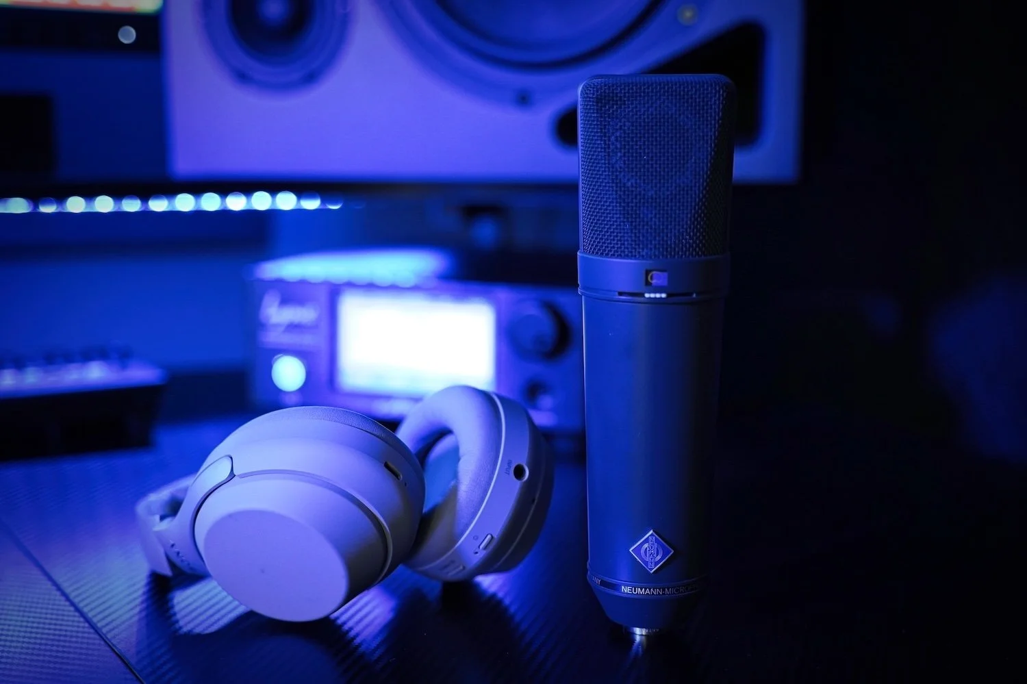 neumann U87 microphone and headphones Sony in a music studio blue light