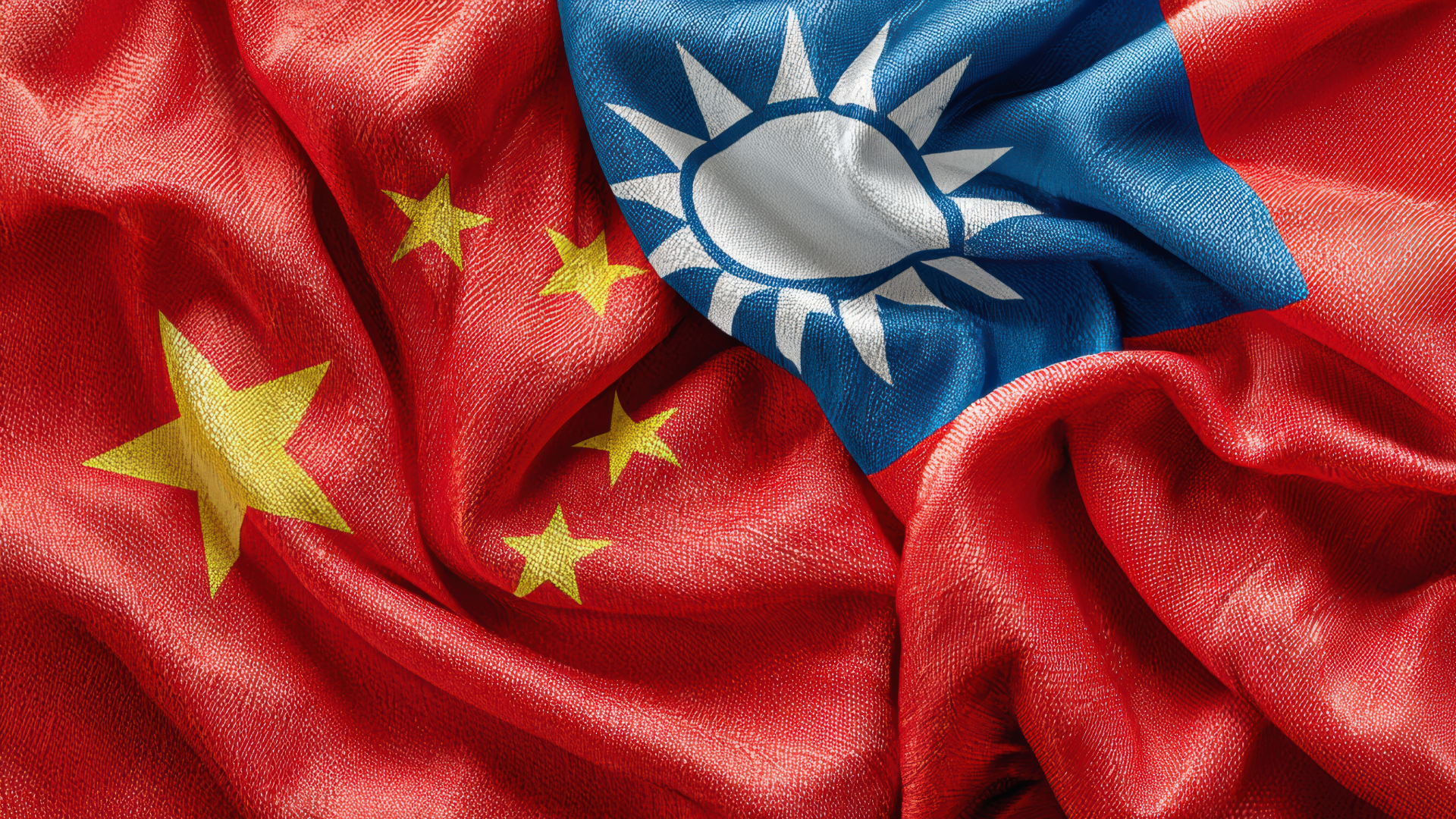 Close-up of the flags of China and Taiwan submerged in fabric, partially overlapping each other