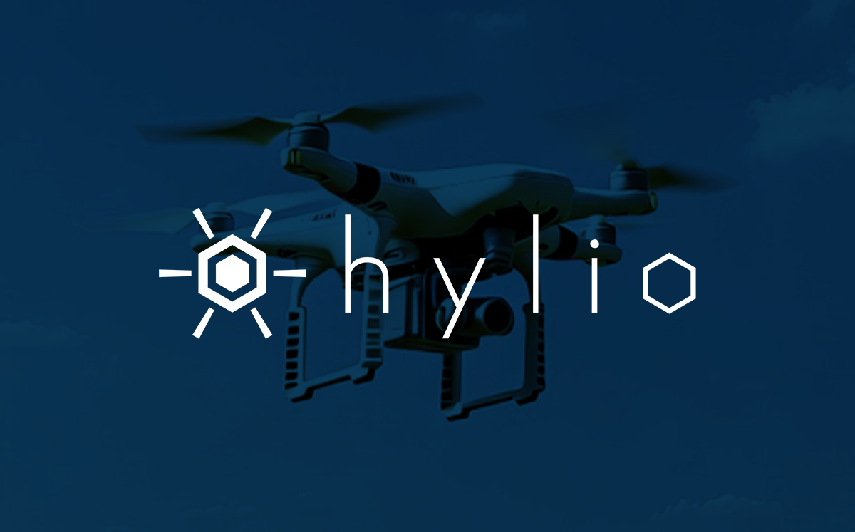 A drone flying in the sky, with a logo of a hexagon and the brand name 'hylio' overlaid.