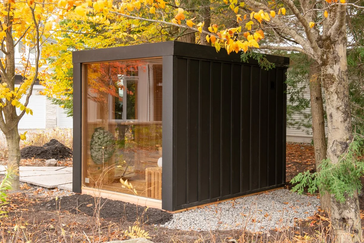 Modern sauna with glass and wooded view