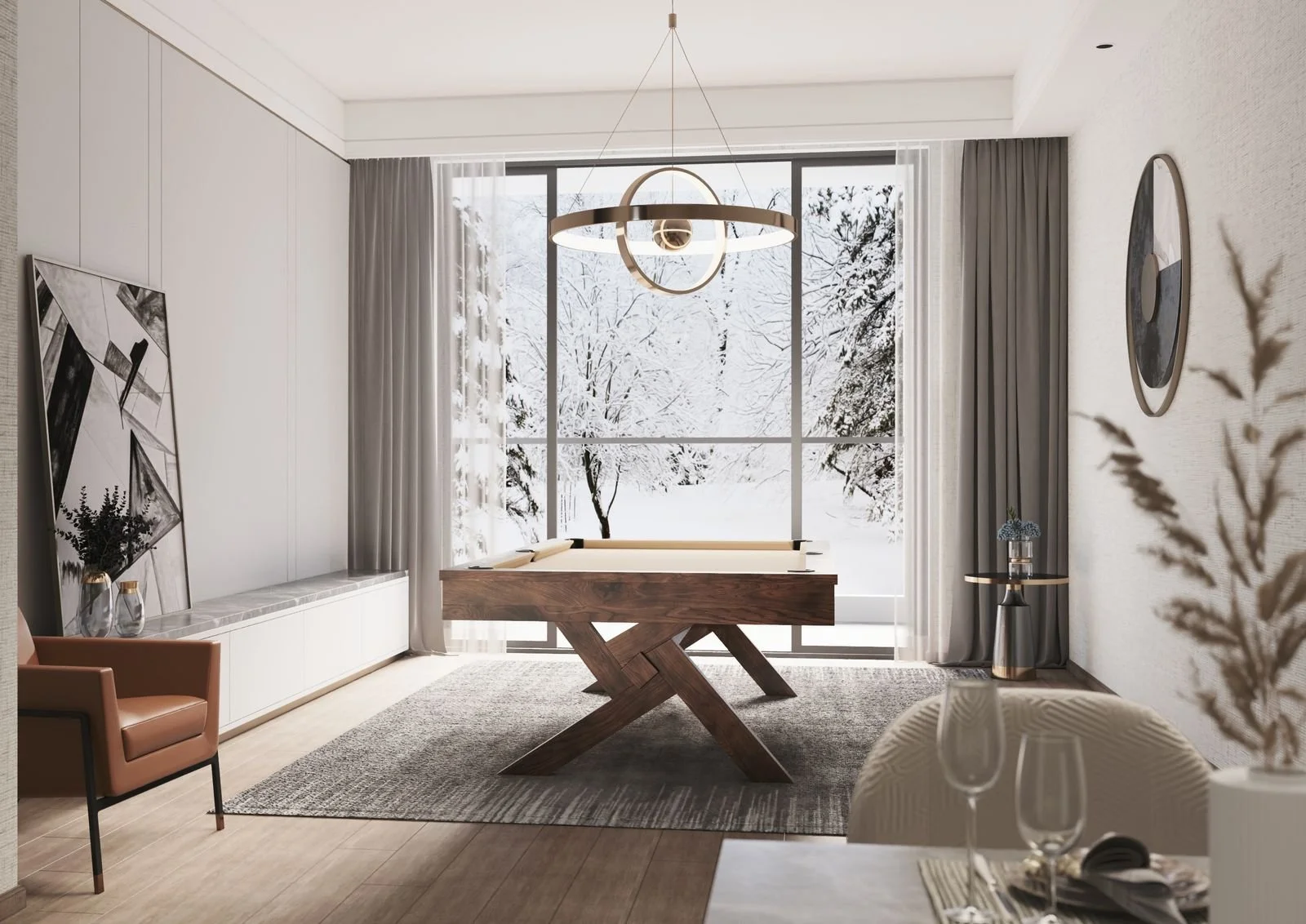 Modern living room with large window showing snow-covered trees outside, a wooden ping-pong table, abstract art, a tan armchair, a gray rug, and a chandelier.
