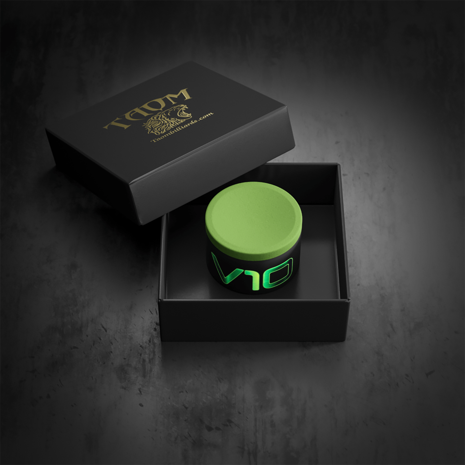 A black box with gold lettering and a lion logo, containing a small black container with a neon green lid and glowing green text, all on a dark surface.