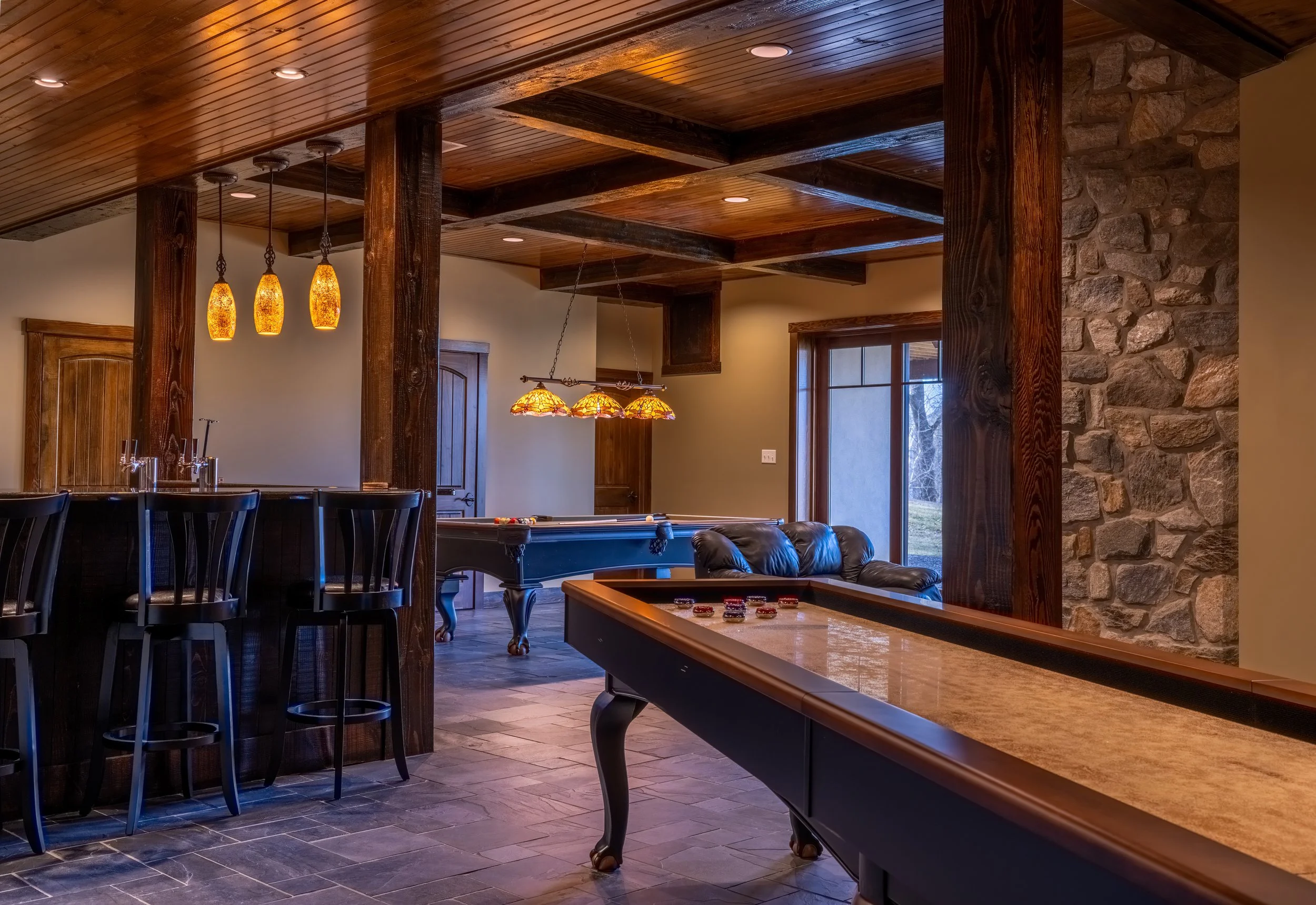 Olhausen Billiards shuffleboard table in rustic decor.