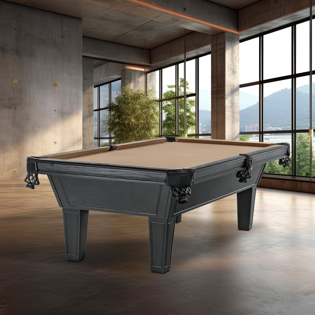 A pool table in a modern, spacious room with large windows, concrete walls, and a view of mountains in the background.