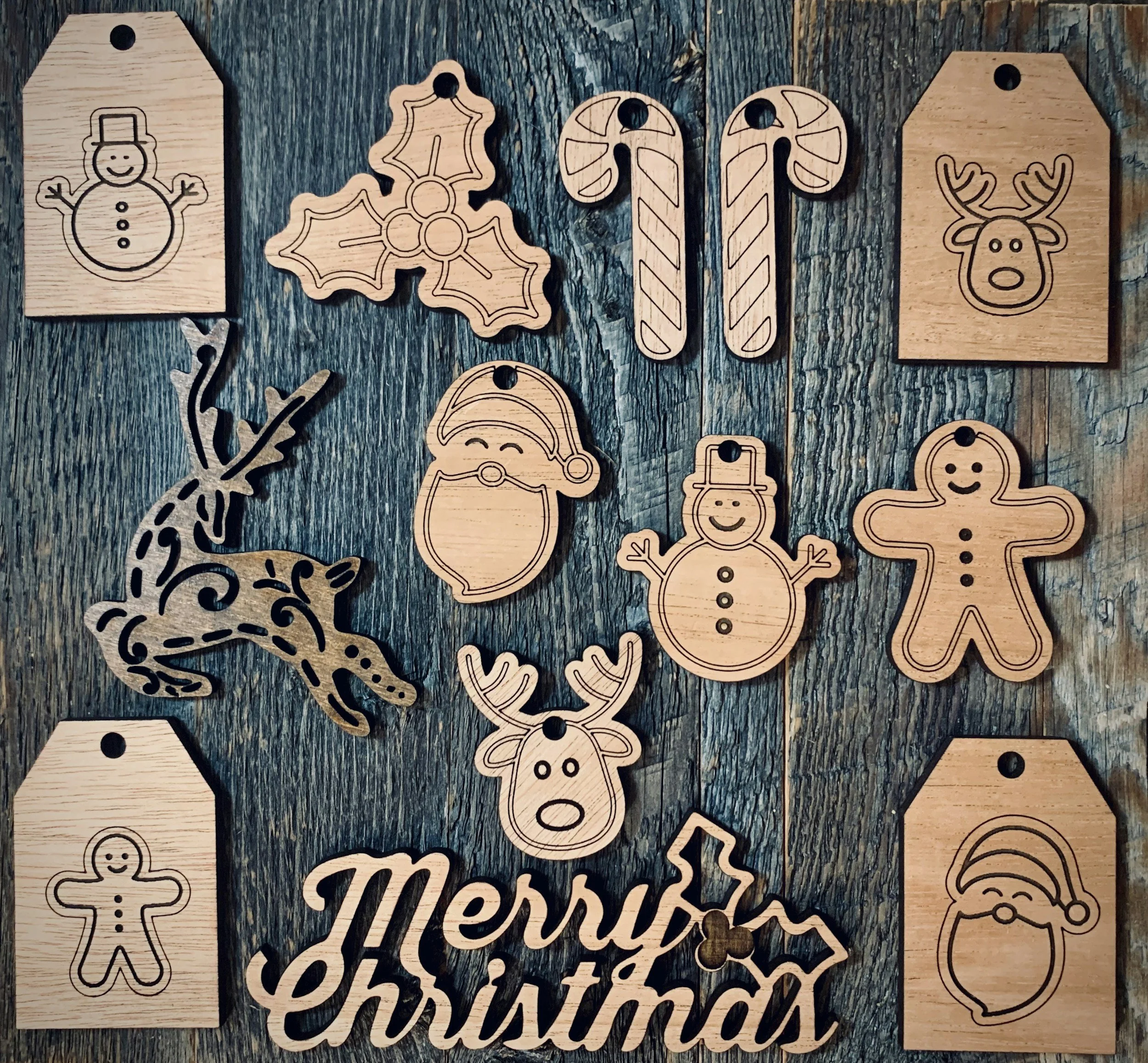 Collection of wooden holiday decorations arranged on a rustic wooden surface, including snowflakes, reindeer, Santa Claus, gingerbread figures, holly leaves, candy canes, Christmas sign, and gift tags with festive illustrations.