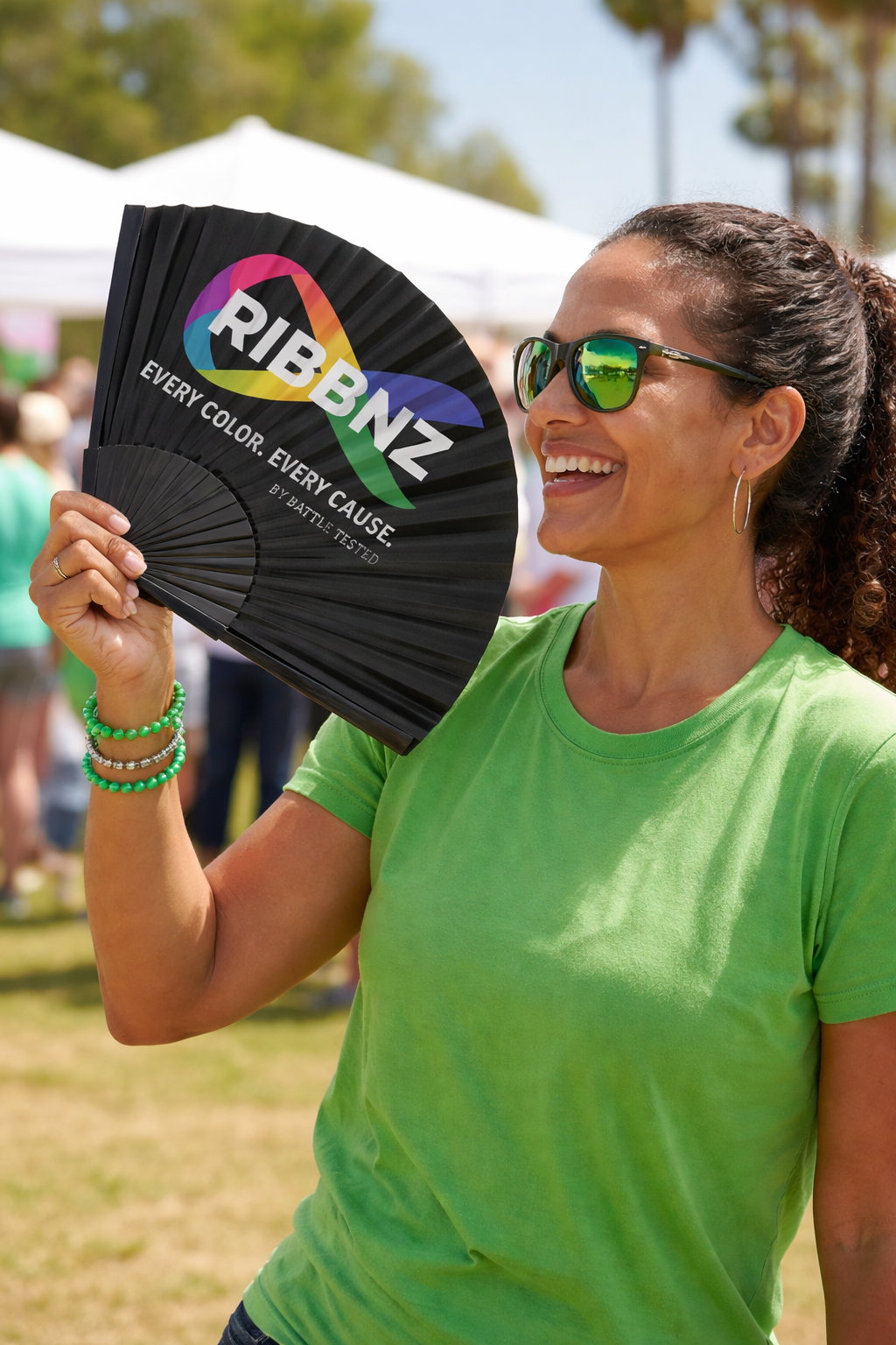 Woman fanning with RIBBNZ fan.png