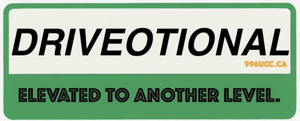 A sign with the word "DRIVEOPTIONAL" in large black text, a small orange website URL "996UCC.CA" in the top right corner, and the phrase "ELEVATED TO ANOTHER LEVEL" in smaller black text on a green background.