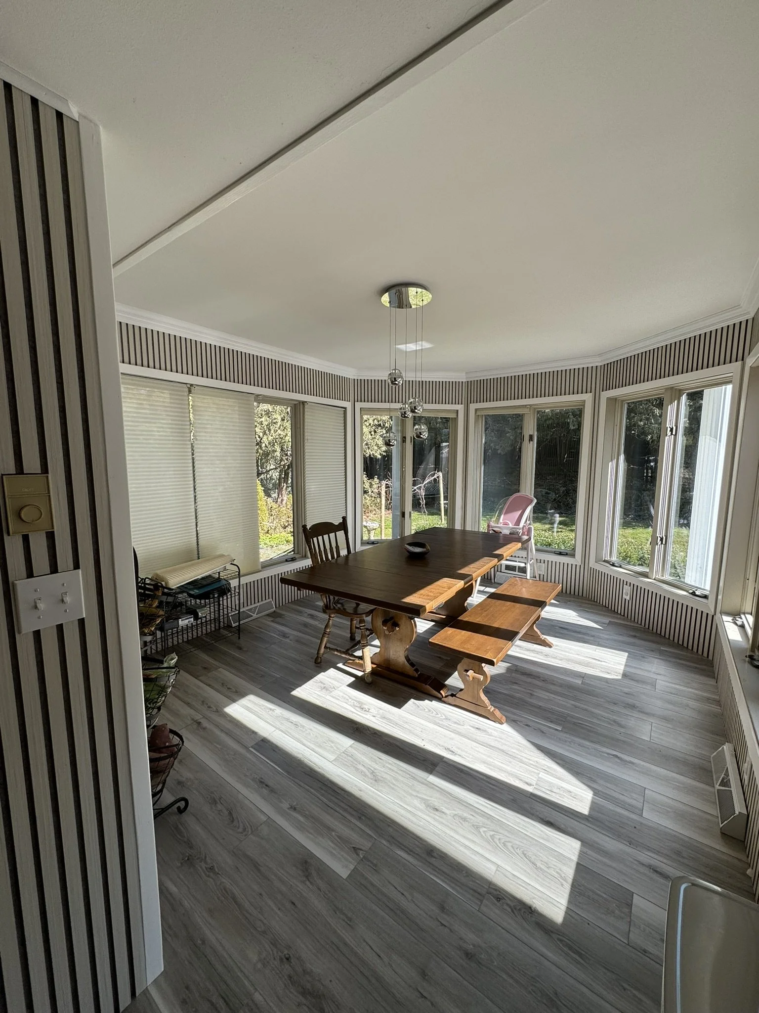 Sun Room in Port Washington AFTER Installing LVP Flooring and Wall Paneling.