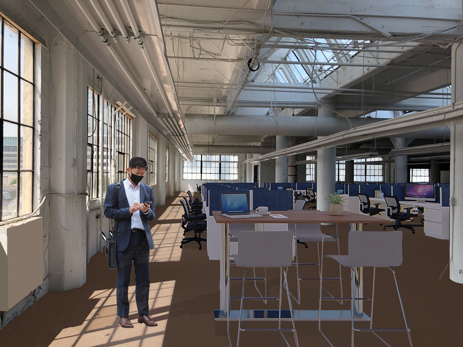 A man in a business suit wearing a black face mask, standing in an open-concept office space with large windows, multiple workstations with computers, and modern office furniture.
