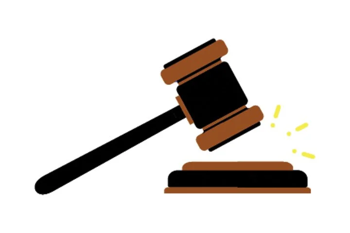 Gavel striking a sounding block, symbolizing legal authority or judgment.