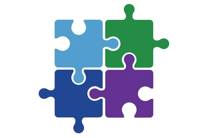 Four interconnected jigsaw puzzle pieces in blue, green, purple, and dark blue colors.