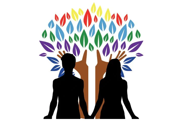 Silhouettes of a man and woman standing in front of a colorful tree with multicolored leaves shaped like flames.