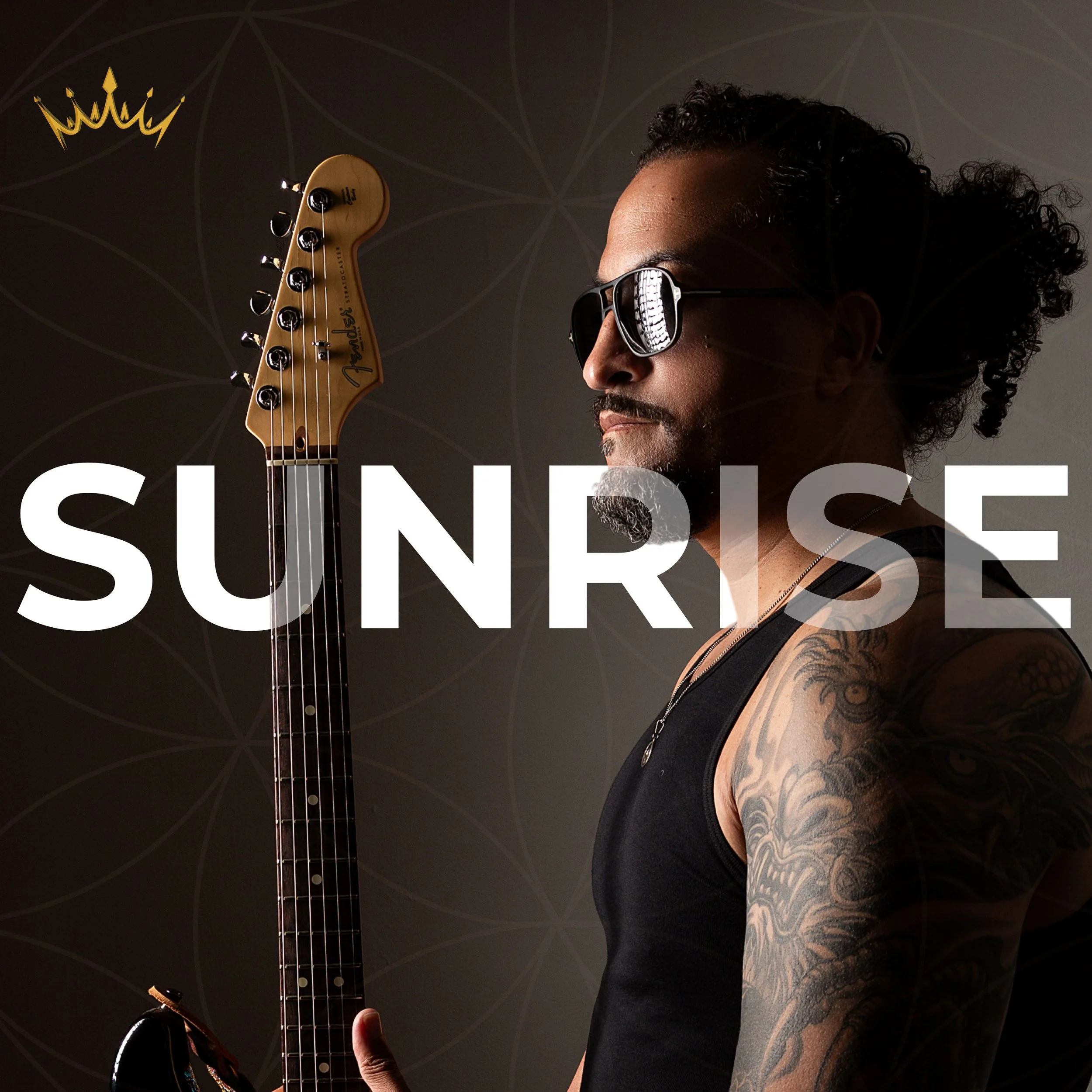 Photograph: Profile view of artist iAM echo 242 wearing sunglasses and holding his Fender Stratocaster guitar. A bright light illuminates his forward facing side creating deep and mysterious shadows to his rear.  SUNRISE is printed across the image.