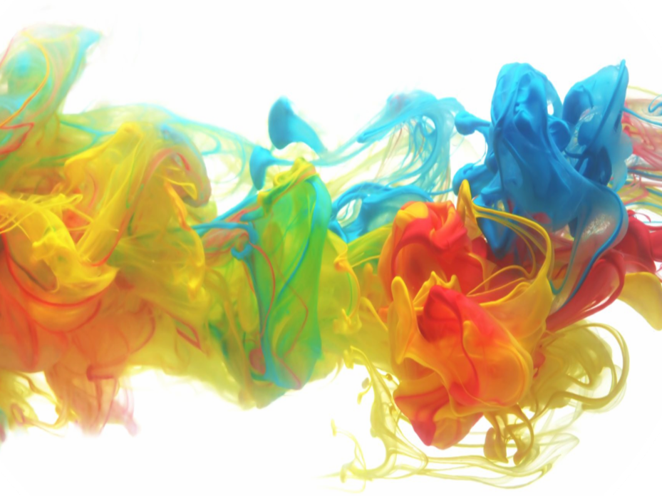 Colorful swirling ink in water with shades of yellow, red, green, and blue