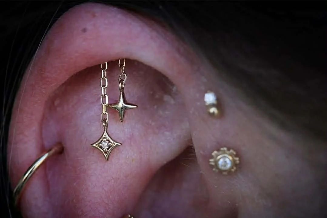 Hidden helix with a yellow gold Cosmo end from Modern Mood Jewelry featuring a genuine white diamond