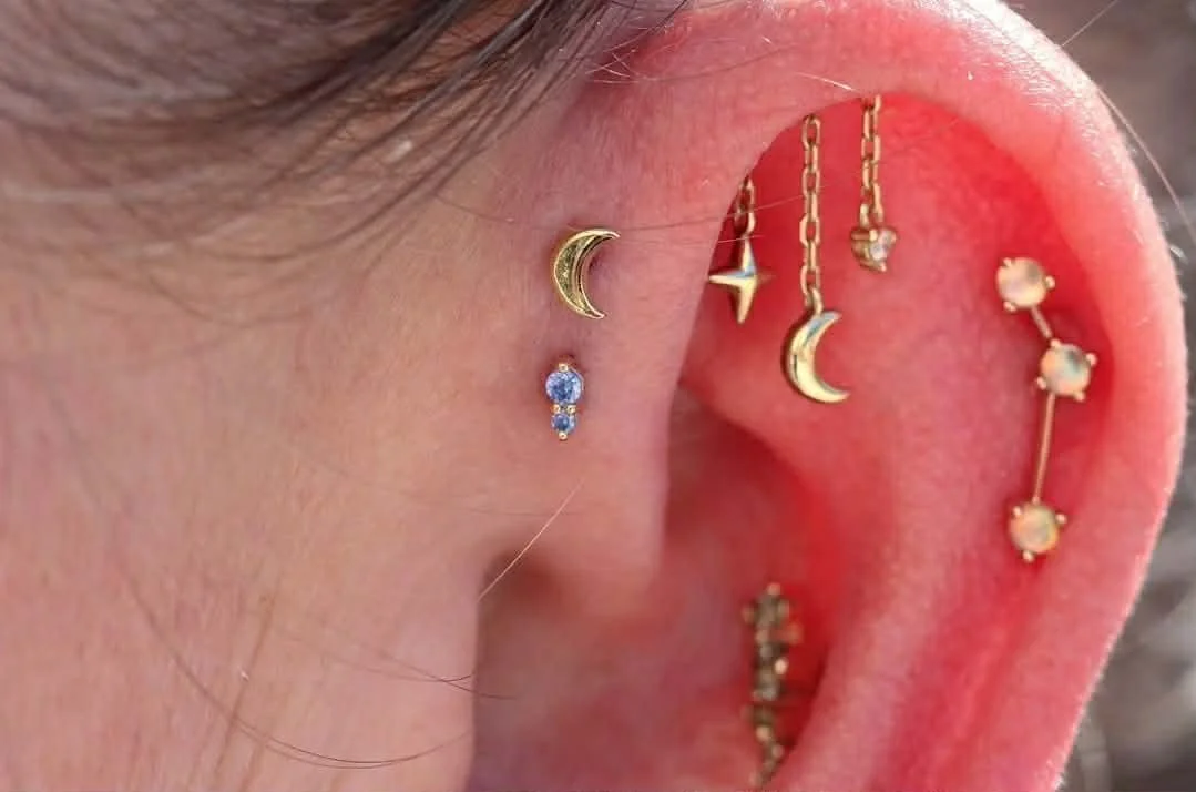 Cute little ear styling
Double forward helix, hidden helix and helix
Norvoch, Ember Jewelry, Modern Mood, genuine white diamond
