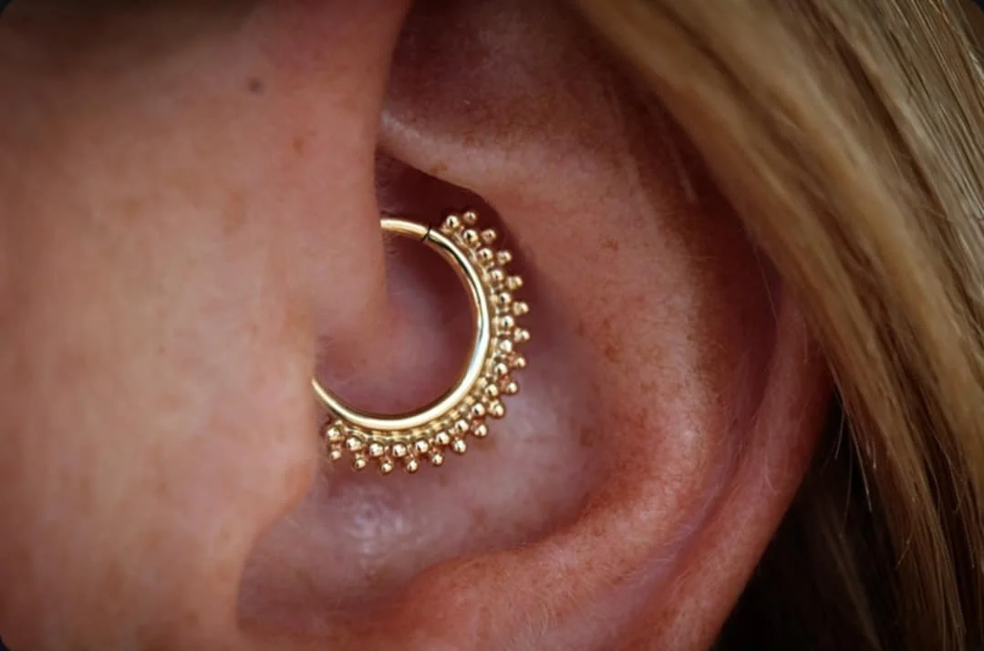 Daith piercing with yellow gold Kolo seam ring by BVLA