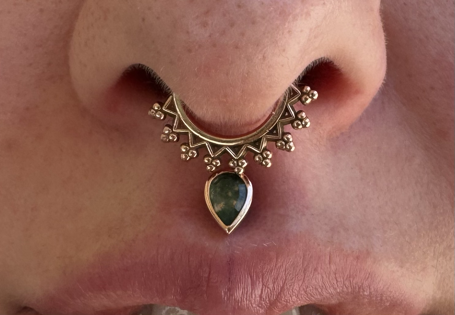 septum piercing with rose gold monarch seam ring from Maya jewelry and a philtrum piercing with rose gold and moss agate from Junipurr jewelry