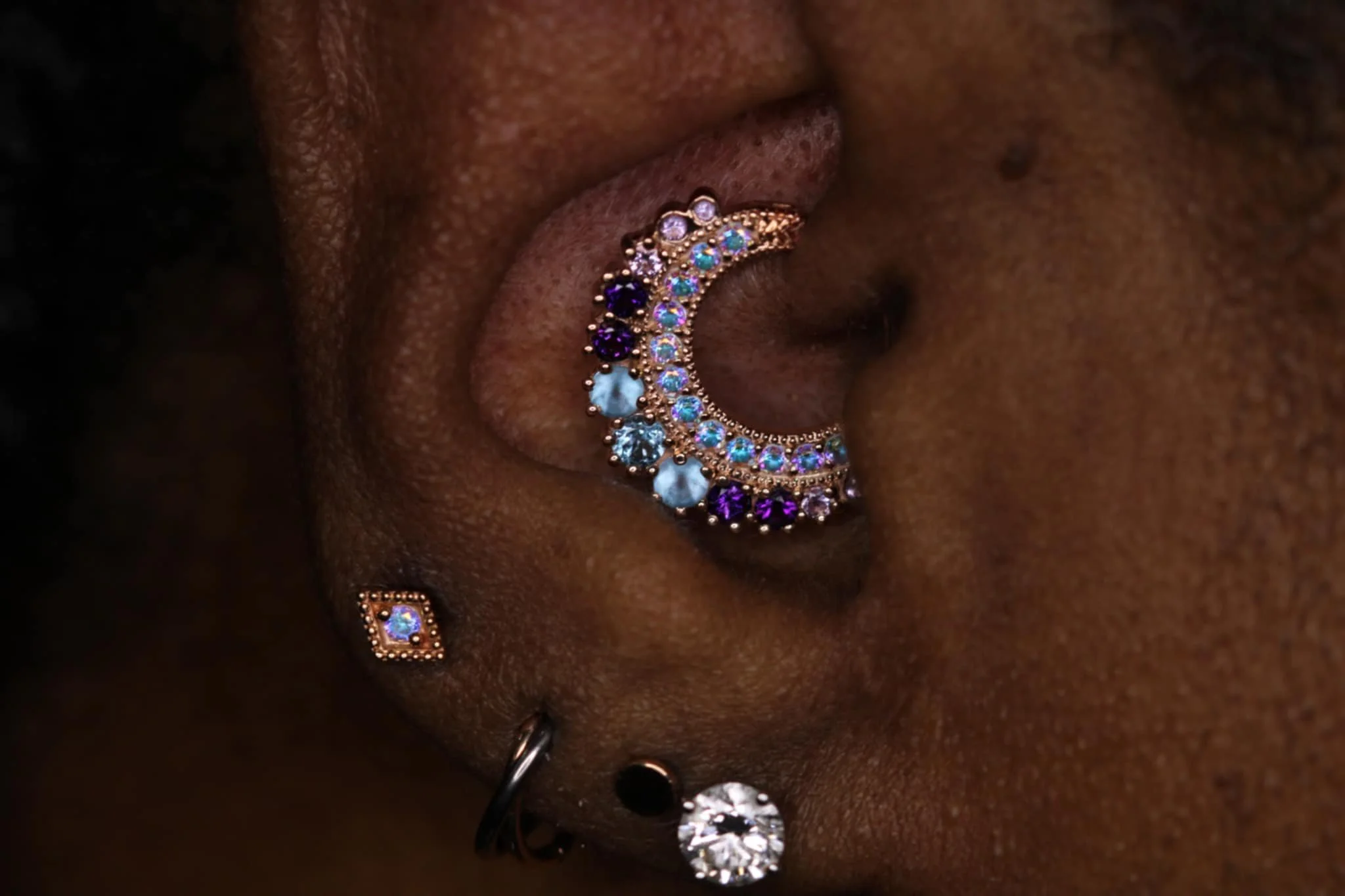 Daith piercing with BVLA Marilyn hinge in rose gold with Mercury Mist Topaz , Swiss Blue Topaz, Amethyst and Light Amethyst